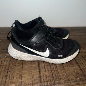 Kids black Nike sneakers.